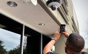 SiteOwl technician taking a picture of a security camera from SiteOwl Mobile App